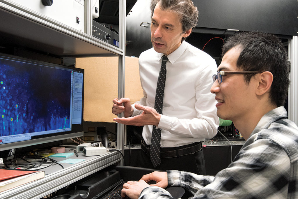 Over the past decade, Azad Bonni, MD, PhD, has contributed insights on how the brain is hardwired, and how neurons take shape and connect to each other. He also is determining how mutations in proteins implicated in autism cause problems. Here, Bonni (standing) confers with staff scientist Yue Yang, PhD. 