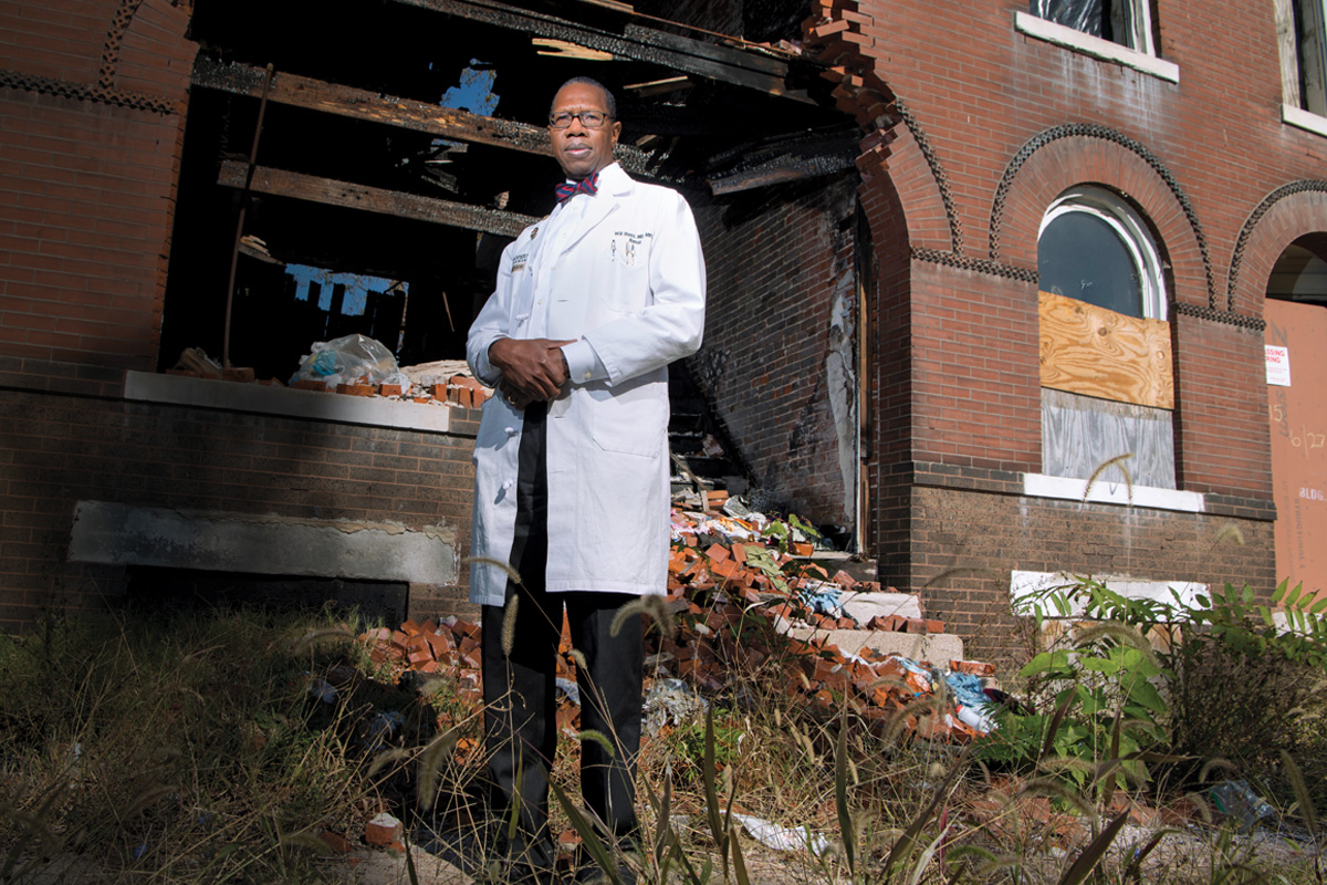 Will Ross stands in front of a dilapidated building in St. Louis.